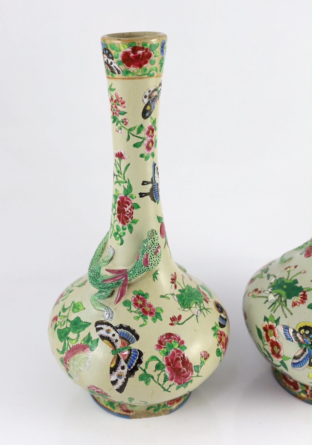 A pair of Chinese enamelled porcelain crackle glaze bottle vases, mid 19th century, 33cm high, chips to feet